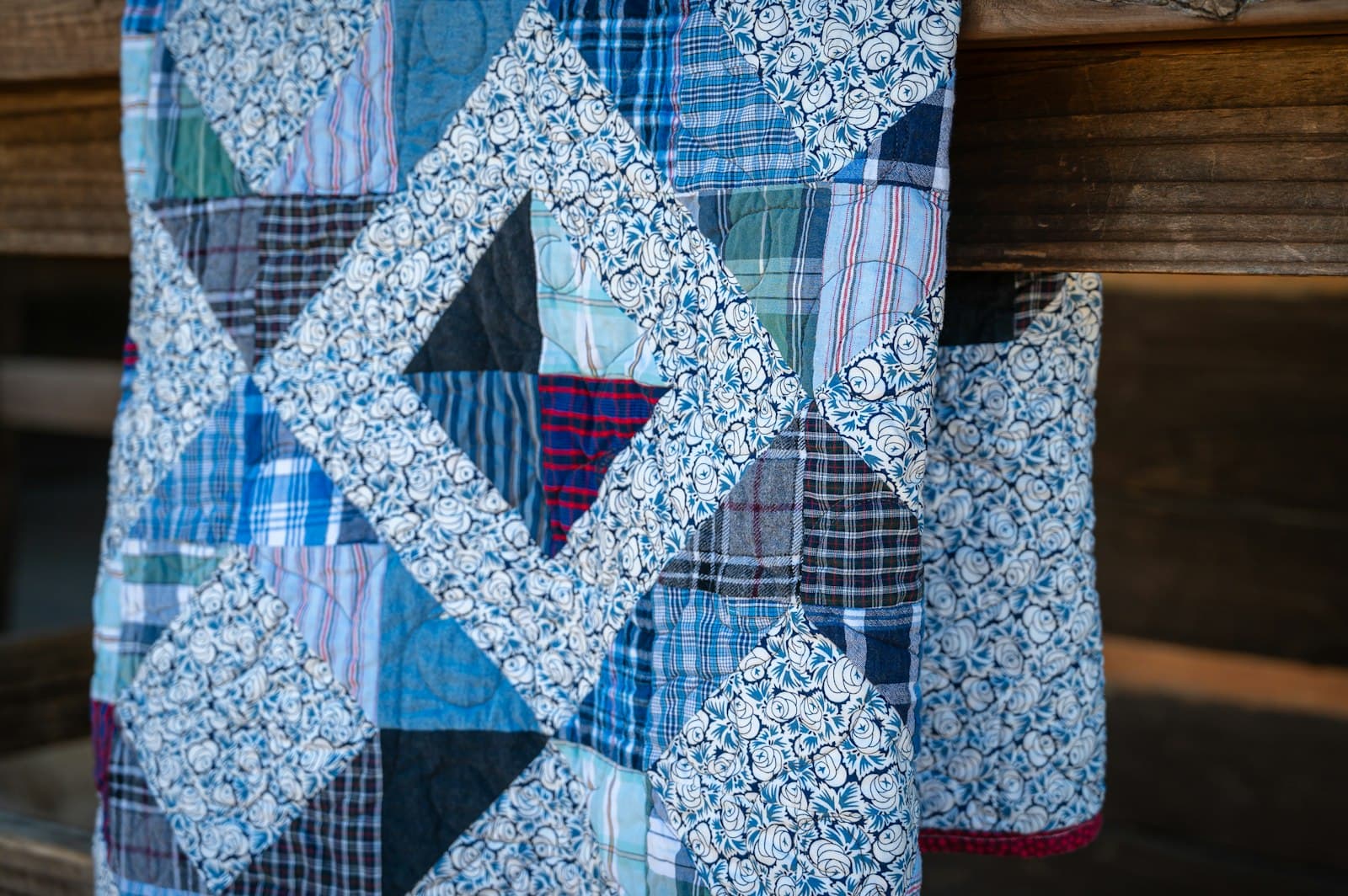 Close-up of a pieced quilt showing geometric block seams