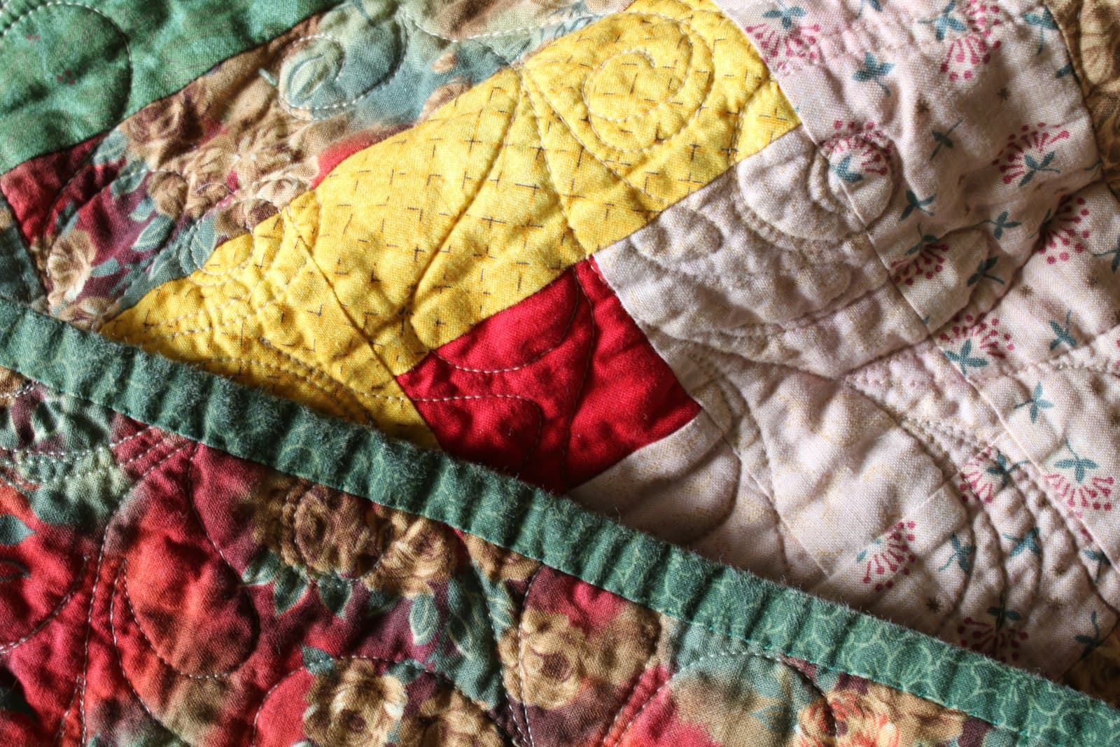 Close-up of a colorful patchwork quilt on a bed