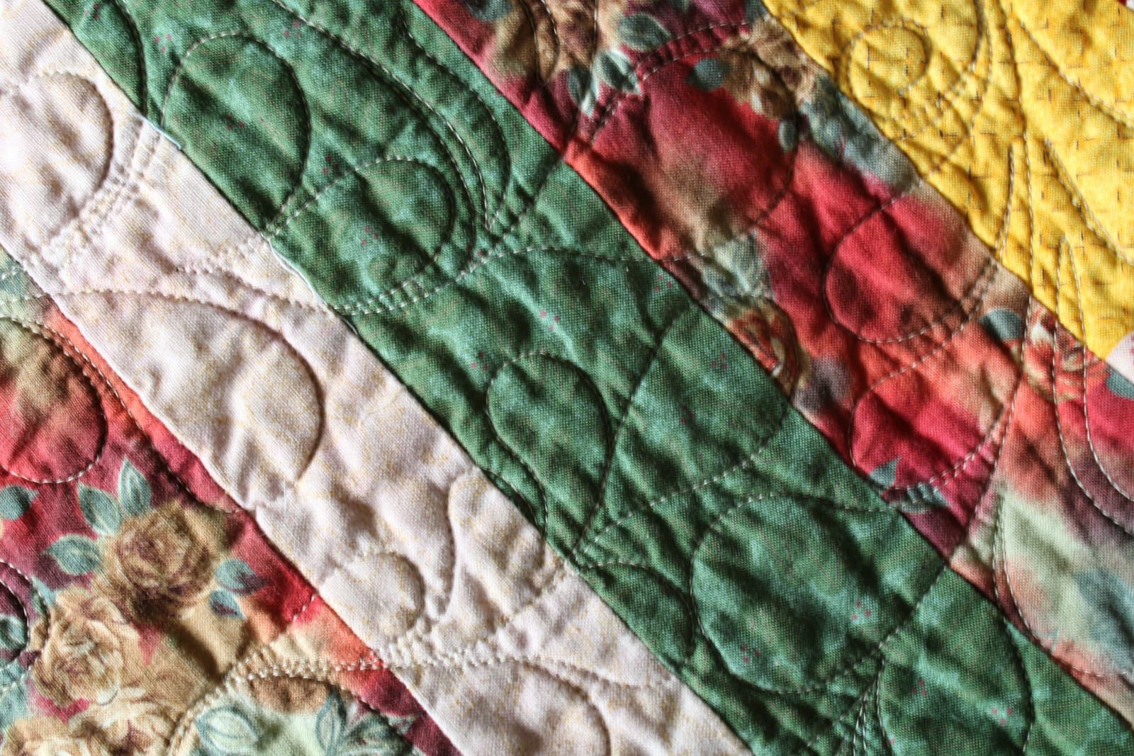 Close-up of a colorful patchwork quilt, second angle